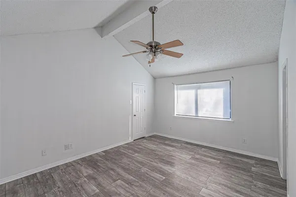 a view of a room with a ceiling fan and a window
