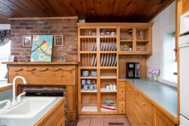 a kitchen with granite countertop a sink appliances a counter space and a window