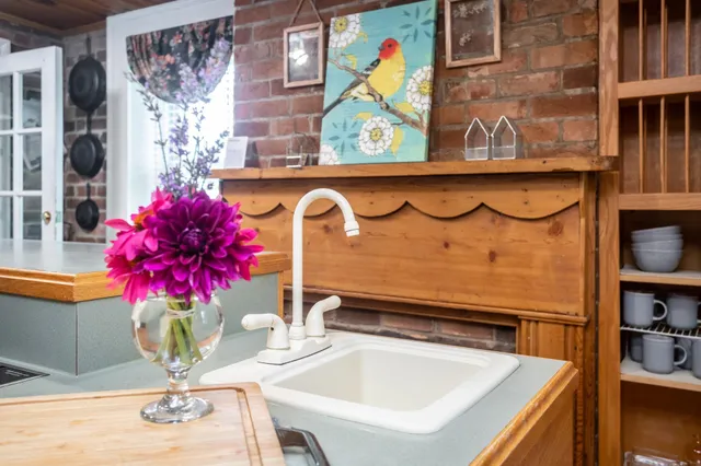 a living room with furniture a large window and wooden floor