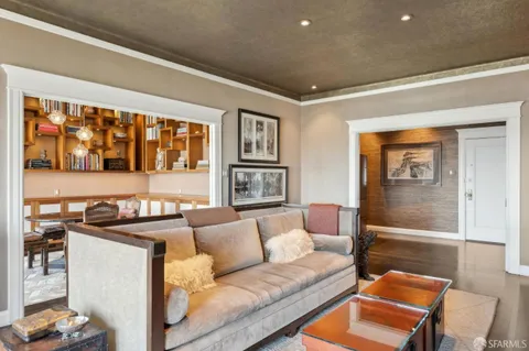 a living room with furniture and a book shelf