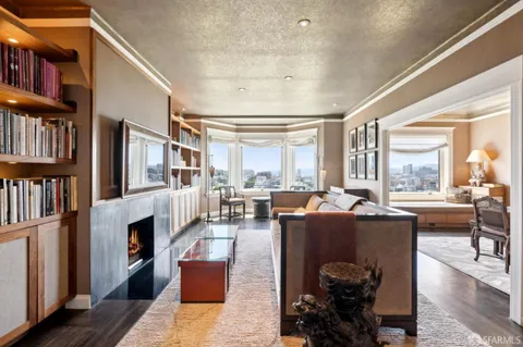 a view of spacious bedroom with a bed and chandelier