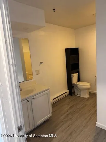 a bathroom with a sink a toilet and a mirror