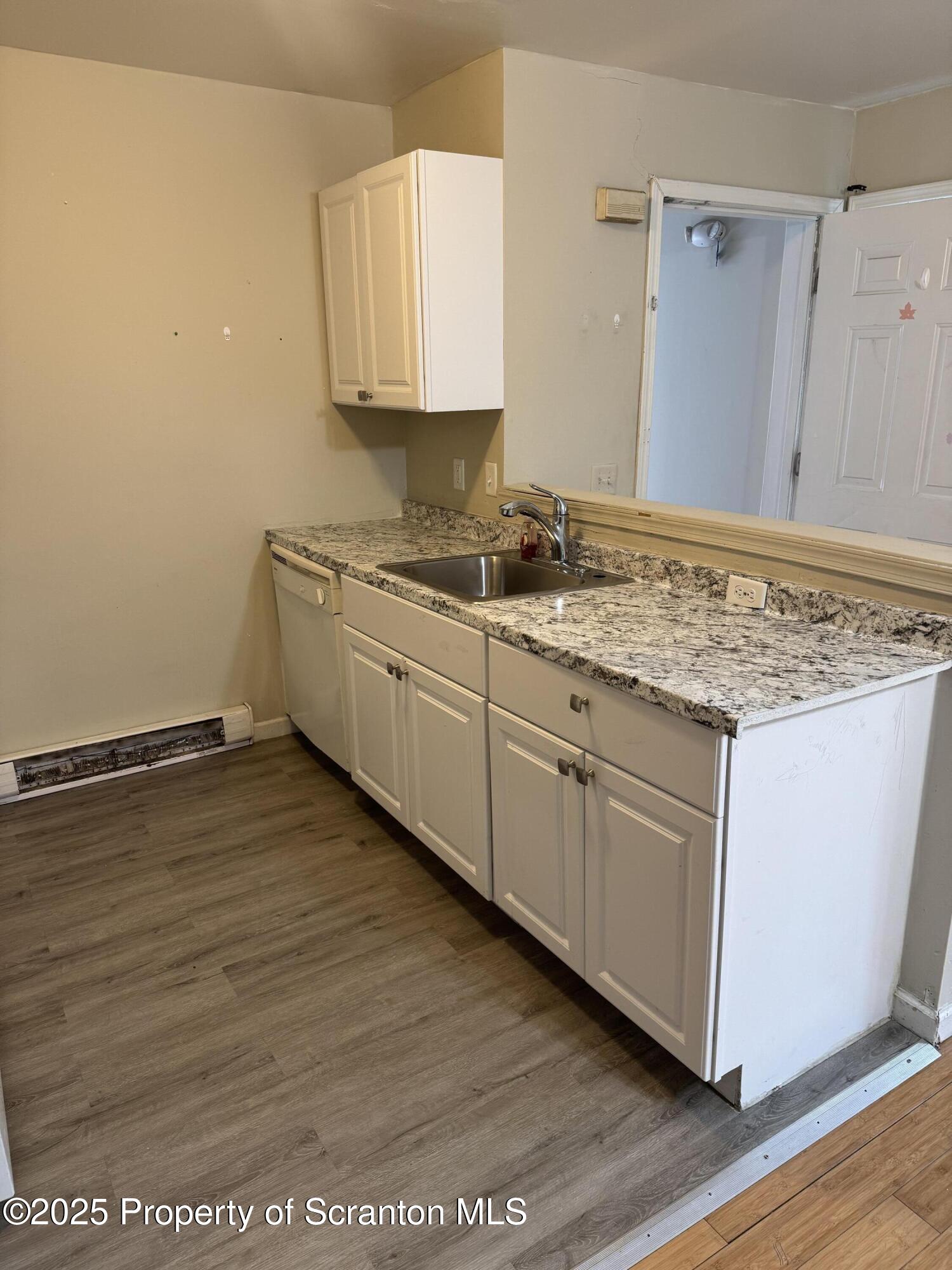 114 Prospect Avenue, Unit 1ST FL FRONT Scranton, PA 18505 - Photo 8 of 10 a kitchen with stainless steel appliances granite countertop a sink stove and cabinets