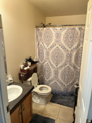 547 East 2000th Street North Vernal, UT 84078 - Photo 28 of 50 Bathroom featuring a shower with a chrome shower rod, a built-in vanity with wood-finish cabinetry, a white basin sink, and tile flooring