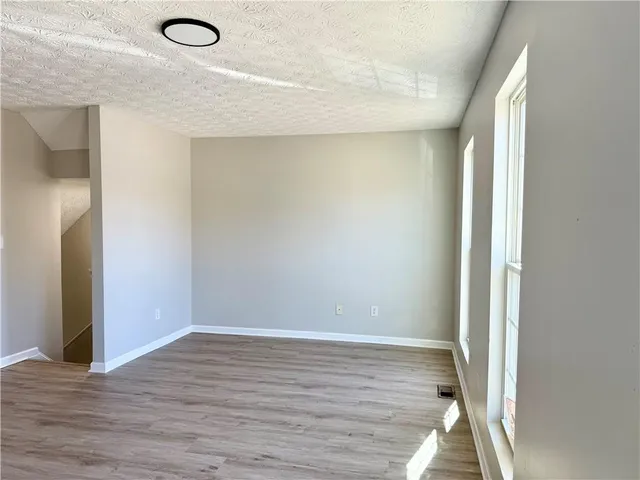 a view of a room with wooden floor