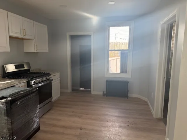 a kitchen with granite countertop a stove and a refrigerator