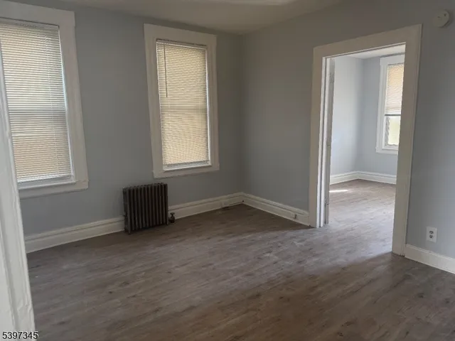 an empty room with windows and closet