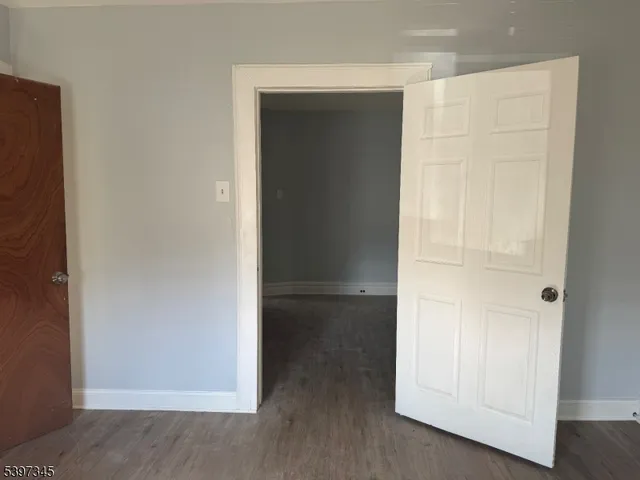 an empty room with wooden floor