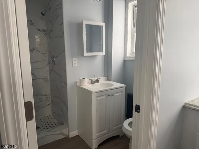 a bathroom with a sink toilet and shower