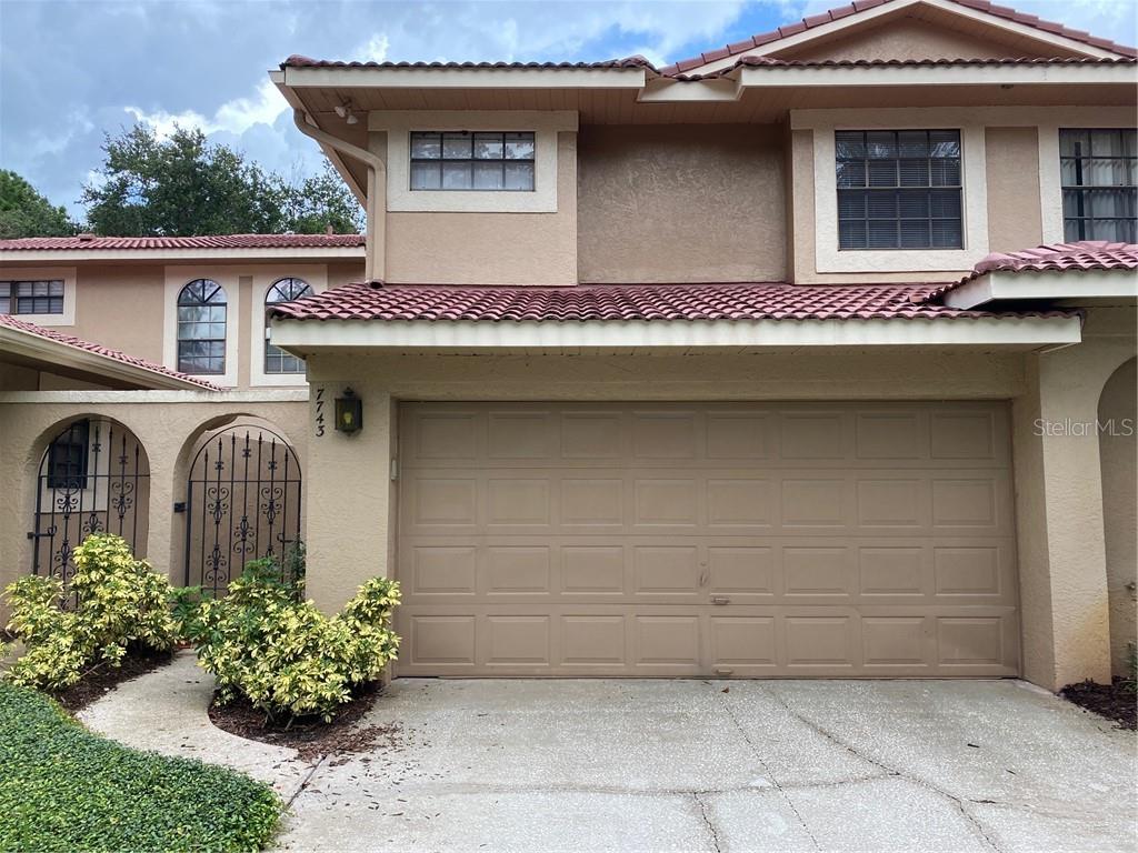 7743 Windbreak Road Orlando, FL 32819 - Photo 1 of 1 a front view of a house with garden