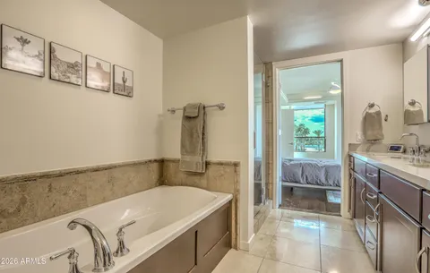 a bedroom with a bed window and table