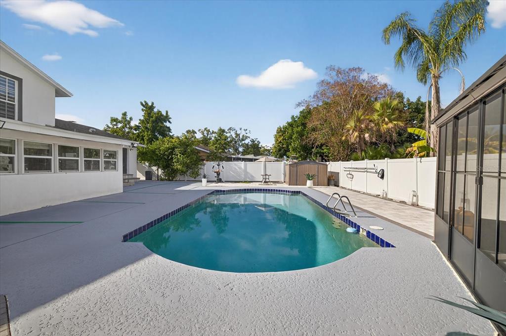 7613 Rustic Drive Tampa, FL 33634 - Photo 22 of 68 a view of outdoor space yard and swimming pool