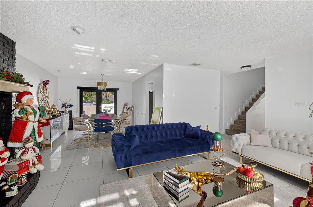 7613 Rustic Drive Tampa, FL 33634 - Photo 30 of 68 a living room with furniture gym equipment and a couch