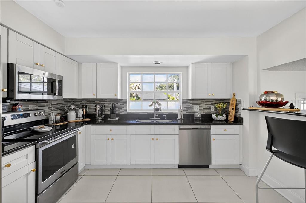 7613 Rustic Drive Tampa, FL 33634 - Photo 39 of 68 a kitchen with granite countertop a sink and cabinets