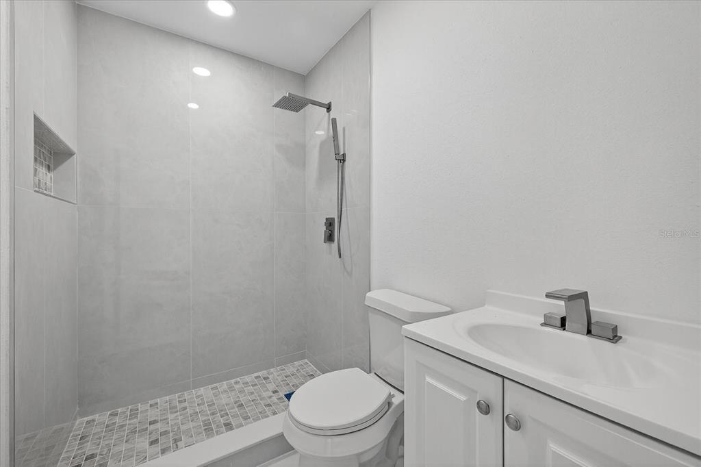 7613 Rustic Drive Tampa, FL 33634 - Photo 44 of 68 a bathroom with a sink a toilet and shower