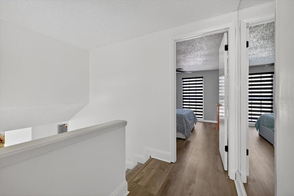 7613 Rustic Drive Tampa, FL 33634 - Photo 46 of 68 a view of hallway with wooden floor