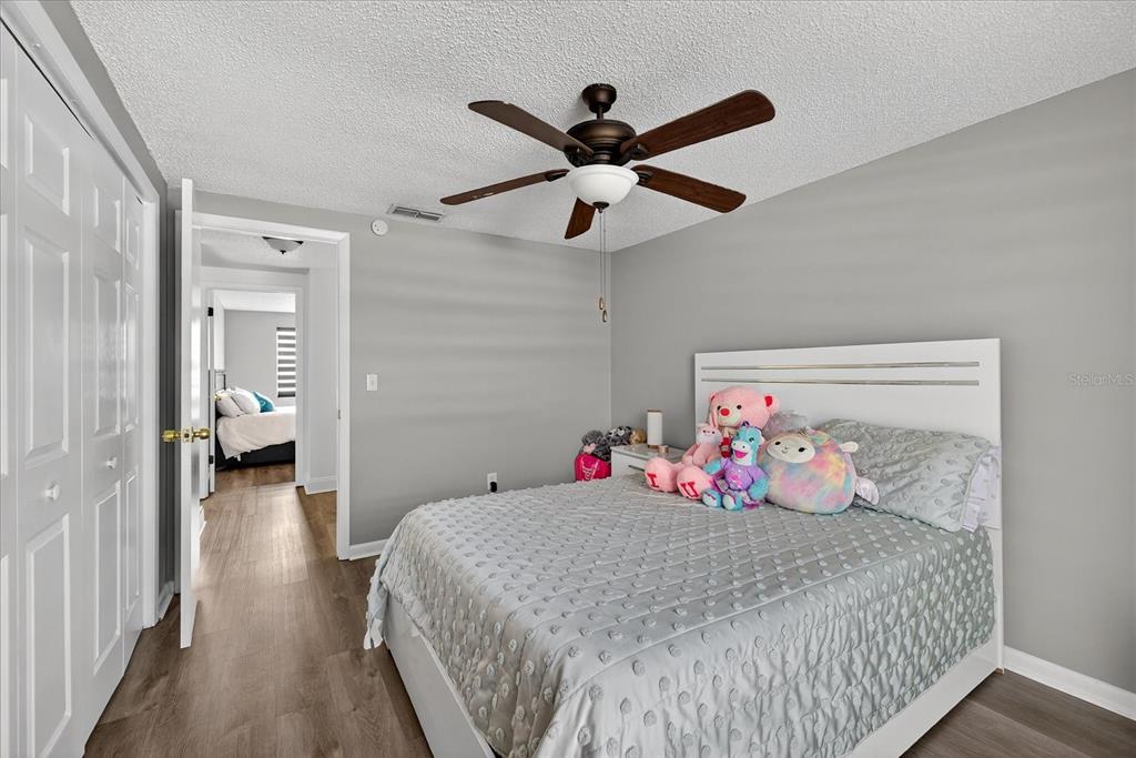 7613 Rustic Drive Tampa, FL 33634 - Photo 48 of 68 a bedroom with a bed and a chandelier