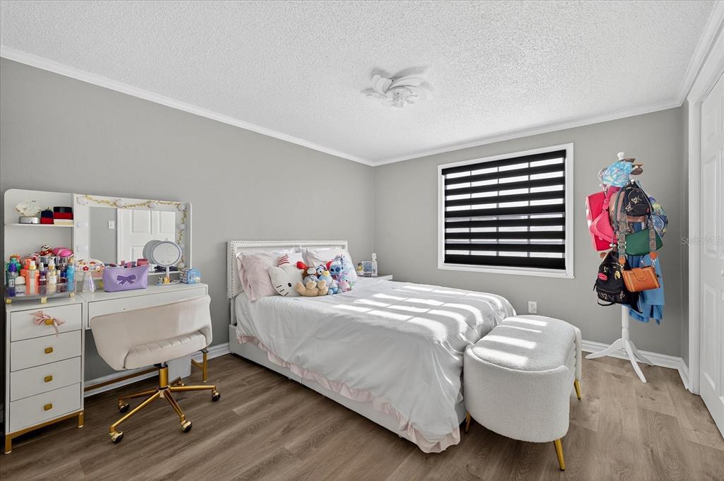 7613 Rustic Drive Tampa, FL 33634 - Photo 54 of 68 a bedroom with a bed and a bookshelf