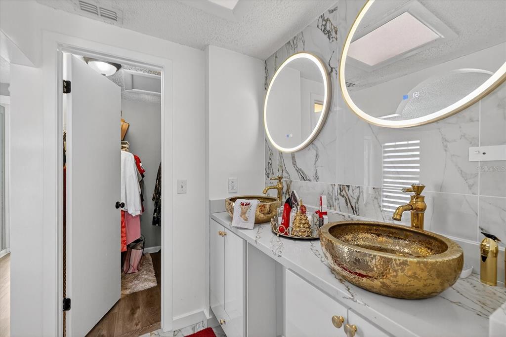 7613 Rustic Drive Tampa, FL 33634 - Photo 61 of 68 a bathroom with a sink and a mirror