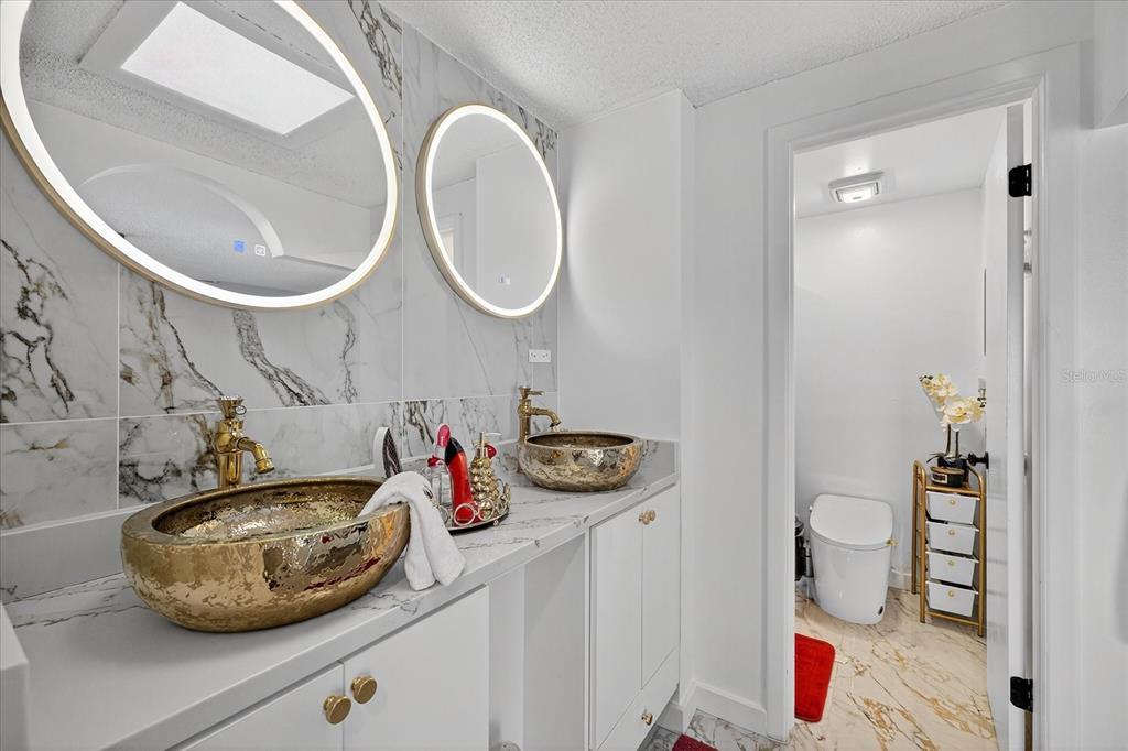 7613 Rustic Drive Tampa, FL 33634 - Photo 62 of 68 a bathroom with a sink and a mirror