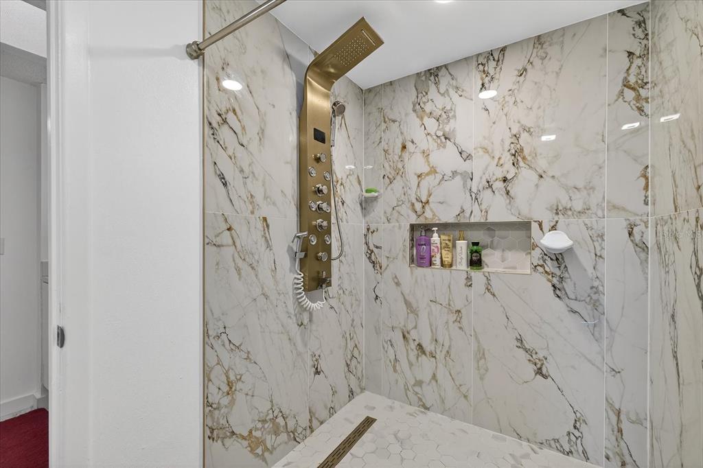 7613 Rustic Drive Tampa, FL 33634 - Photo 64 of 68 a bathroom with a shower curtain