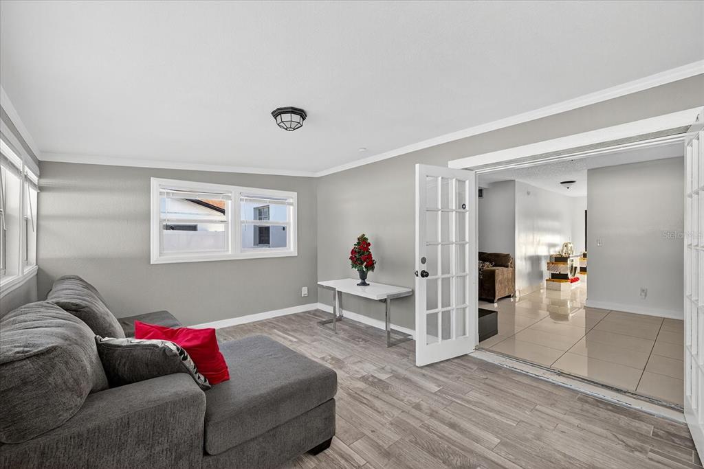 7613 Rustic Drive Tampa, FL 33634 - Photo 67 of 68 a living room with furniture and a wooden floor