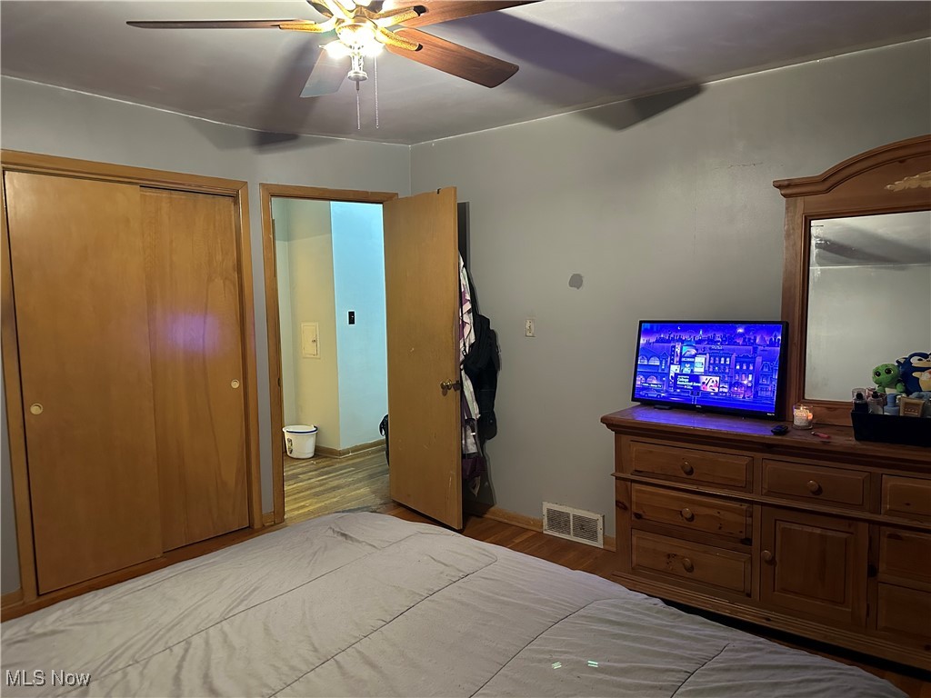 12303 Orme Road Garfield Heights, OH 44125 - Photo 13 of 22 Bedroom featuring visible vents, a ceiling fan, and wood finished floors
