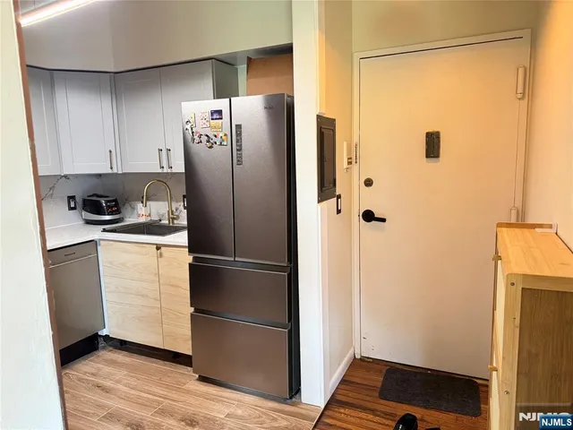 a kitchen with a refrigerator and cabinets