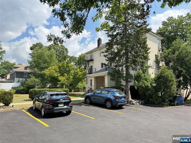 a view of a car parked in front of a house