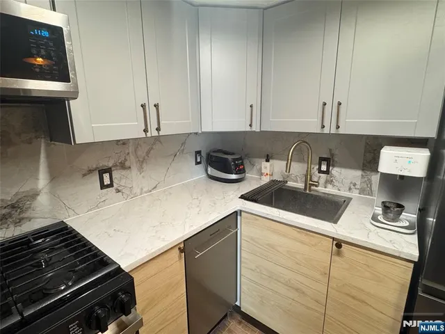 a kitchen with a sink and cabinets