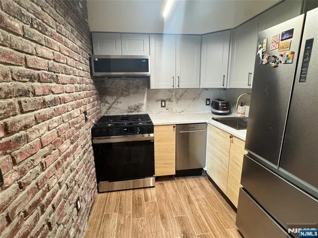 a kitchen with a stove a sink and a refrigerator