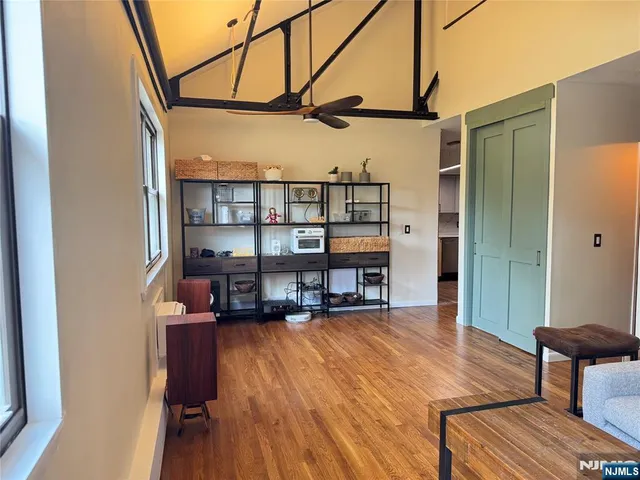 a view of a workspace with furniture and wooden floor