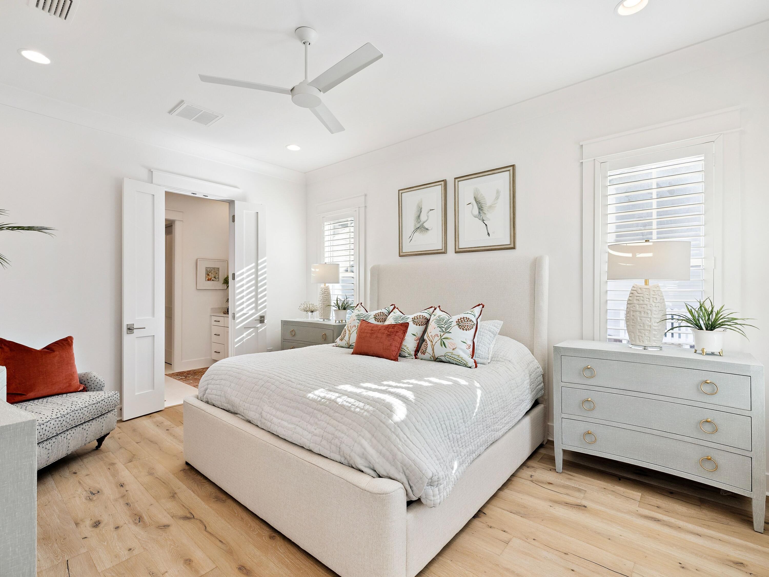 39 West Firethorn Circle Watersound, FL 32461 - Photo 20 of 33 a bedroom with a large bed and a chandelier