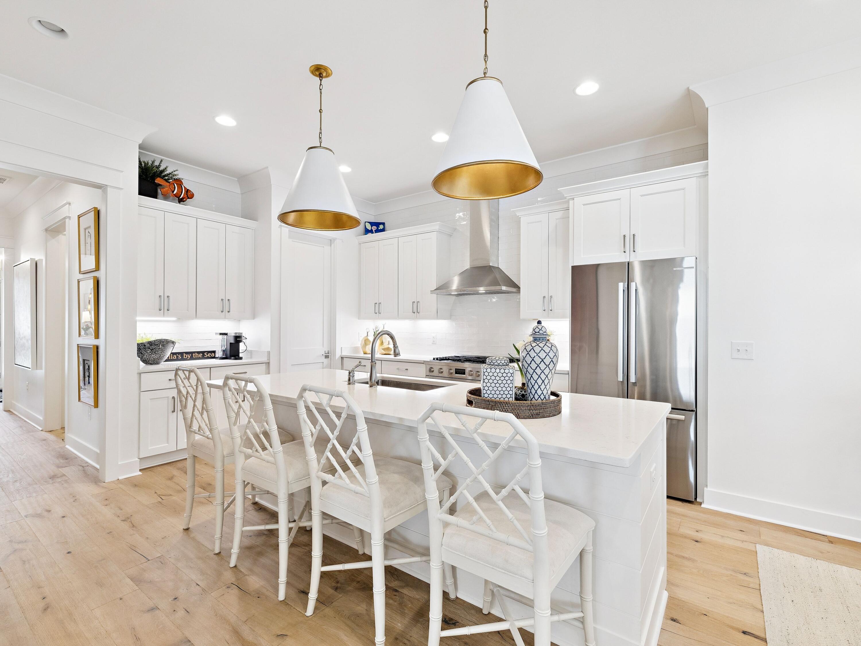39 West Firethorn Circle Watersound, FL 32461 - Photo 2 of 33 a kitchen with stainless steel appliances kitchen island granite countertop a stove a refrigerator cabinets and a dining table