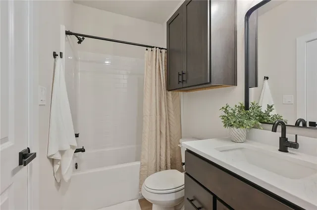 a bedroom with a bed a chair and potted plant