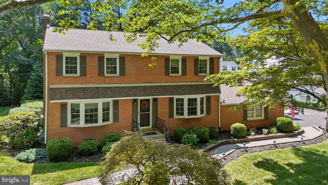 a front view of a house with yard and green space