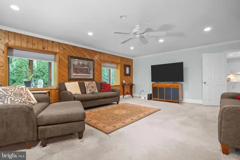 a kitchen with kitchen island granite countertop a sink and white appliances