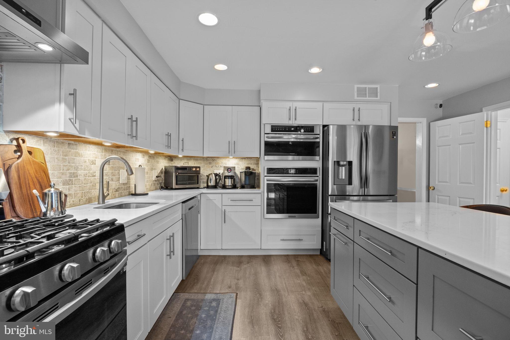 1708 Madeira Avenue Jenkintown, PA 19046 - Photo 16 of 63 a kitchen with kitchen island granite countertop a sink and white appliances