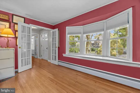 a living room with furniture ceiling windows and a rug