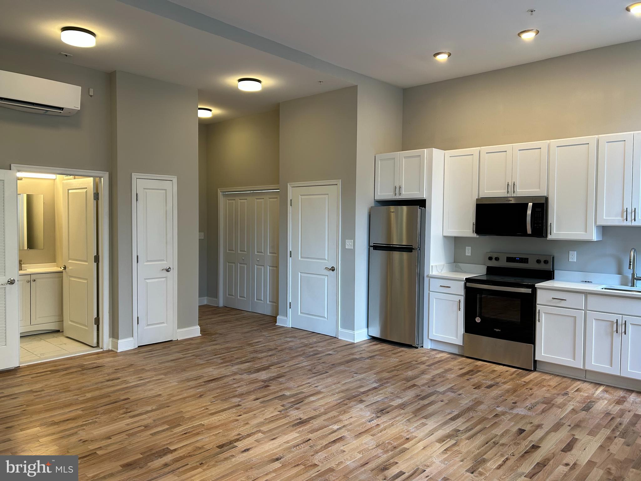 100 West Lexington Street, Unit 404 Baltimore, MD 21201 - Photo 7 of 27 a view of a kitchen with a sink and a refrigerator