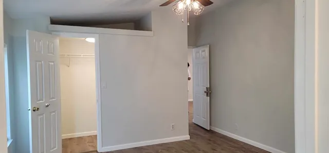 a view of a hallway with a chandelier fan