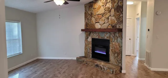 a living room with a fireplace and a window