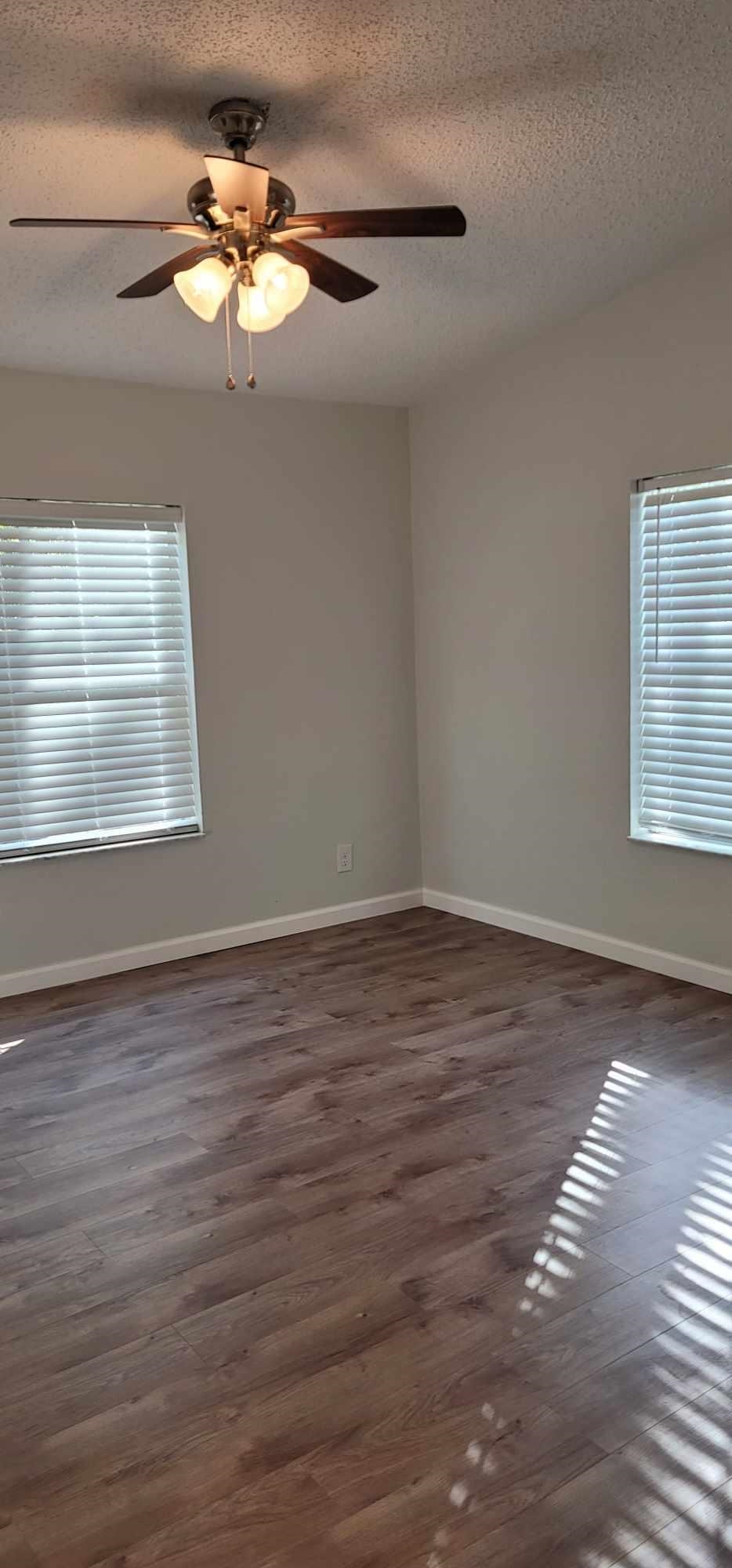 7772 Highway 1, Unit A St. Augustine, FL 32086 - Photo 6 of 14 a view of an empty room with wooden floor and a window