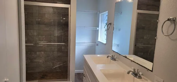 a bathroom with a sink and shower