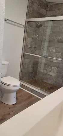 a bathroom with a toilet and a shower