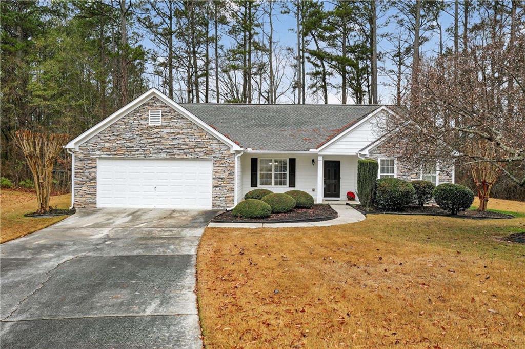 a front view of a house with yard and garage