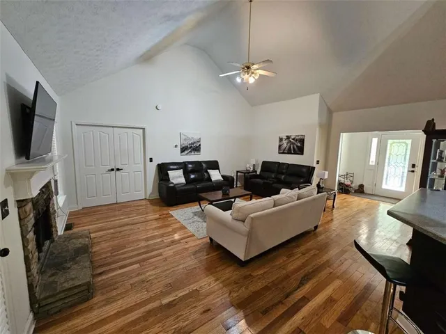 a living room with furniture a fireplace and a flat screen tv
