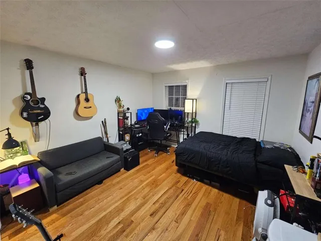 a bedroom with bed and a couch