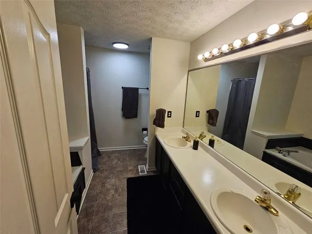 a bathroom with a double vanity sink a and mirror