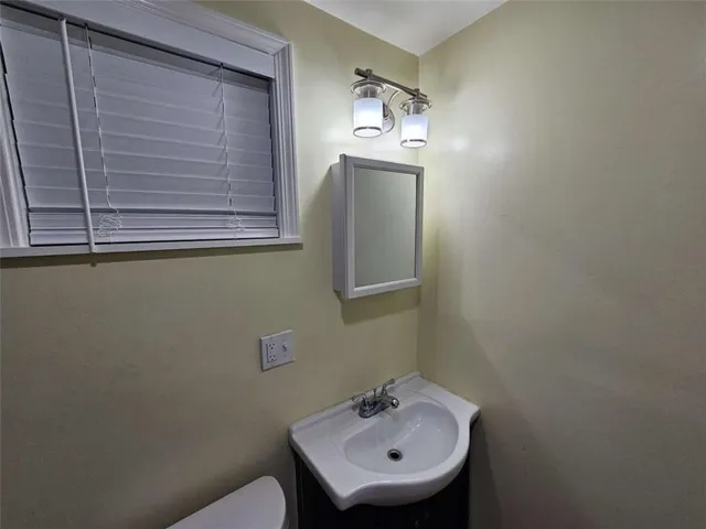 a bathroom with a sink a mirror and a toilet